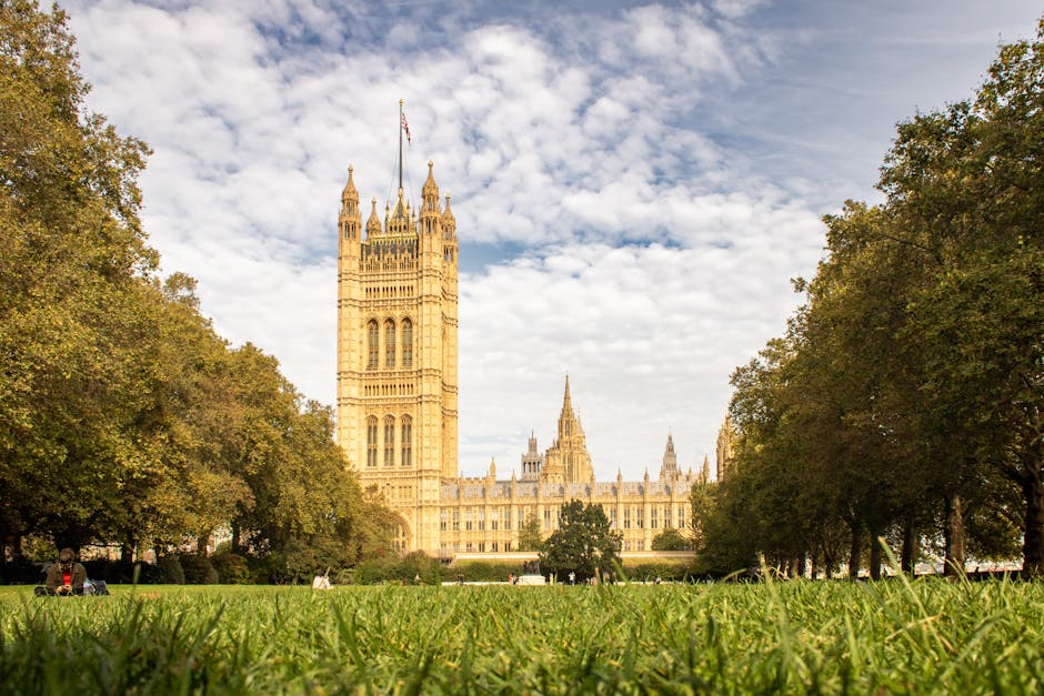 A wide-angle view of the Palace of Westminster in London, showcasing its Gothic Revival architecture with its prominent clock tower, known as Big Ben, standing tall in the center. The building's sands
