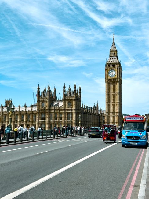 A wide-angle view of the Palace of Westminster in London, showcasing its Gothic Revival architecture with its prominent clock tower, known as Big Ben, standing tall in the center. The building's sands